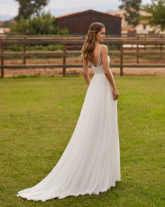 Robe de Mariée Niler collection Alma Novia 2026. Robe légère plis mousseline fente avec cape. Essayer boutique mariage showroom Paris