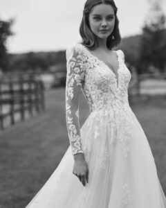 Robe de Mariée Nolir collection Alma Novia 2026. Robe tulle dentelle manches longues et dos en V. Essayer boutique mariage showroom Paris