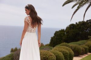 Robe de mariée doridis bianco evento. Robe fluide dentelle fine, pétales petites manches. Essayer boutique mariage Paris showroom RDV